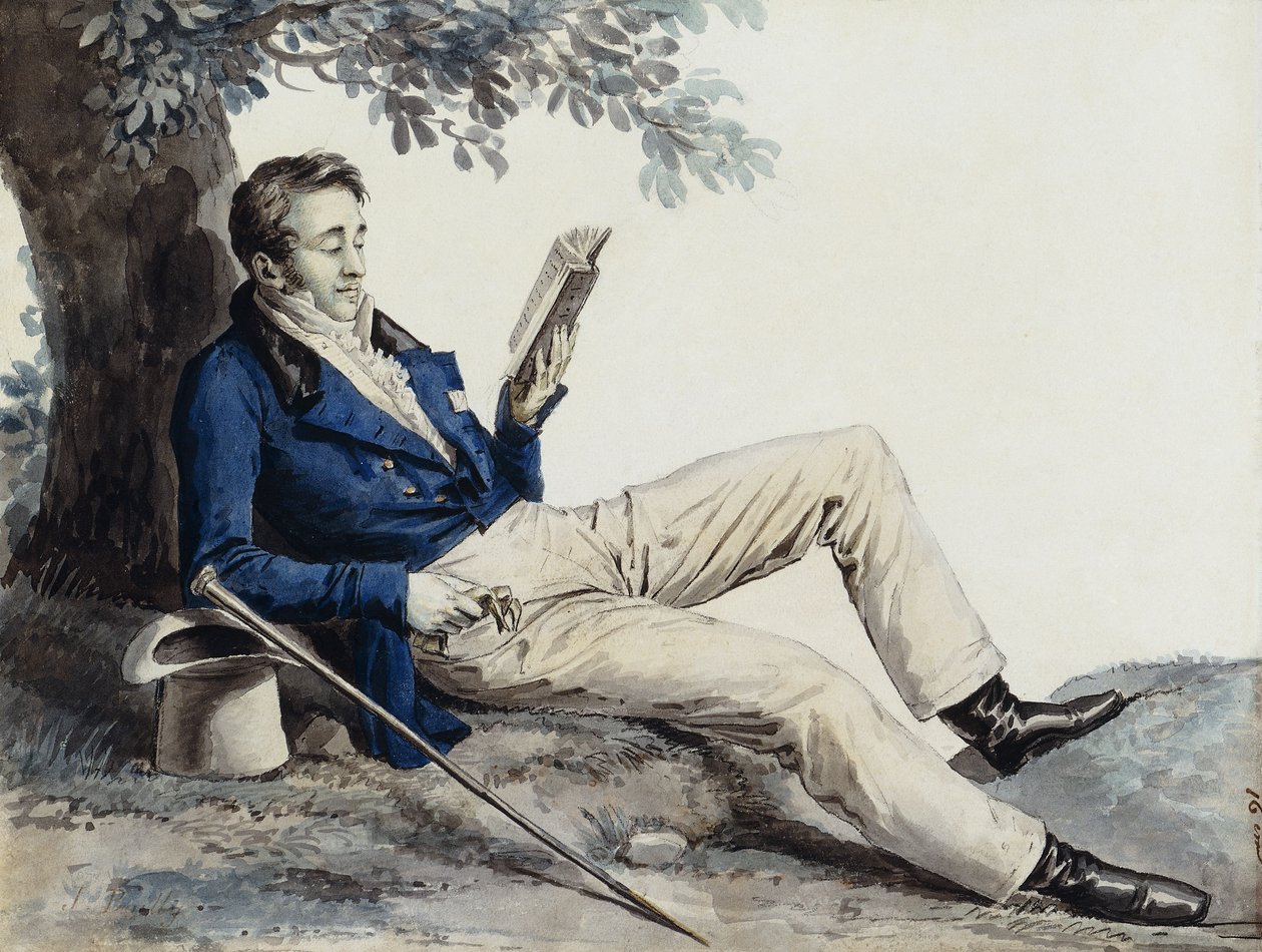 guy reading a book under a tree